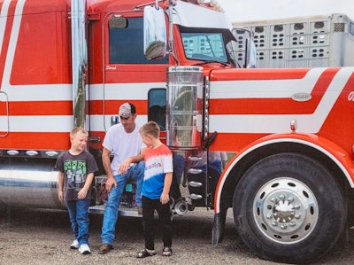 Missing trucker David Schultz and his two sons in front of his truck