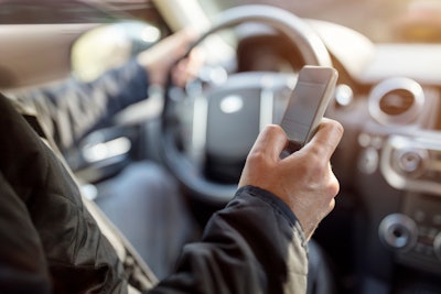 Driver looking at smartphone