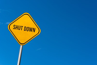 'Shut Down' on yellow highway sign