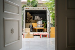 Moving van through open door of a house