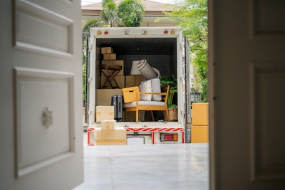 Moving van through open door of a house