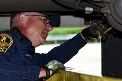 Inspector checking brakes