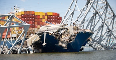 Steel being removed from the containers ship Dali