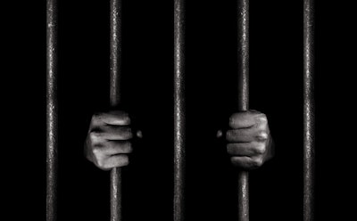 Hand on prison bars