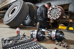 Technician works on truck brakes