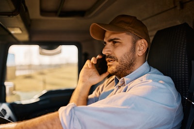 Truck driver talking on cell phone while driving