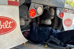 Officer inspecting truck brakes