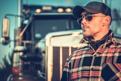 Truck driver in front of truck