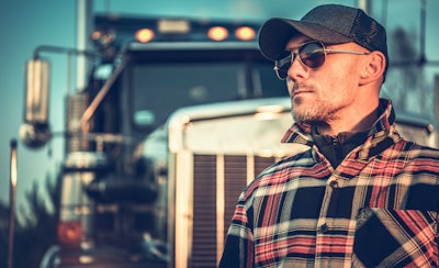 Truck driver in front of truck