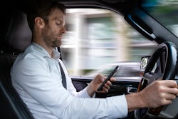 Man using cellphone while driving