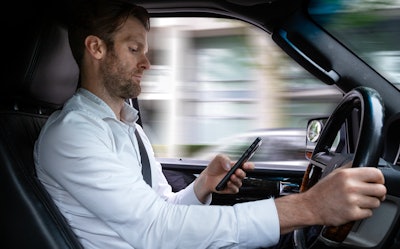 Man using cellphone while driving