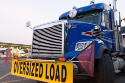 Big rig with 'Oversized Load' sign on front