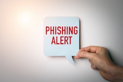 Phishing Alert sign in a person's hand