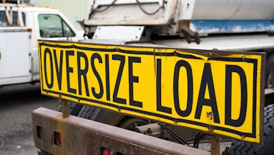 'Oversize Load' on yellow banner on truck
