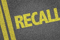 'Recall' in yellow on pavement