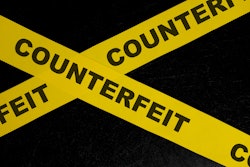 'Counterfeit' on yellow tape on black background