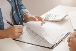 Man signing lease agreement