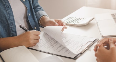 Man signing lease agreement