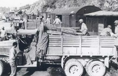 Soldiers with Red Ball Express trucks