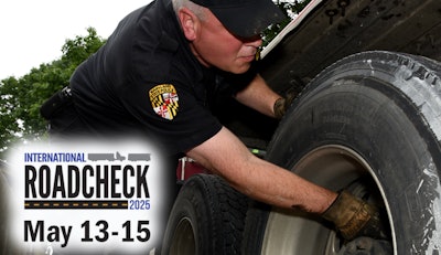 Law enforcement officer inspecting truck tires