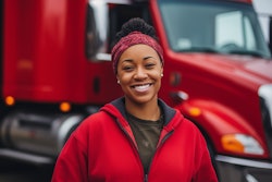 Woman in front of red tractor-trailer