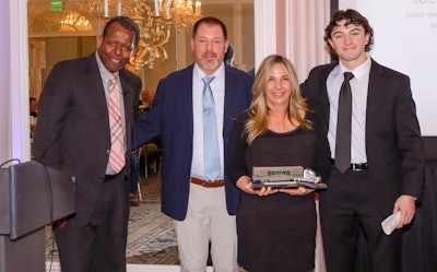 Bekins Director of Traffic Doug Robinson (left) presents Joe Childs (second from left) with the 2024 Bekins Driver of the Year award, which the celebrated driver accepted with his wife Cheri (second from right) and son Joey (far right) at his side.