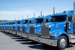 Long row of blue heavy-duty trucks