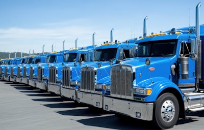 Long row of blue heavy-duty trucks