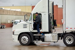 Driver getting into tractor-trailer