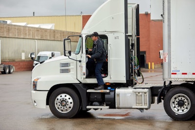 Driver getting into tractor-trailer