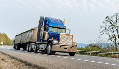 Blue tractor-trailer on highway