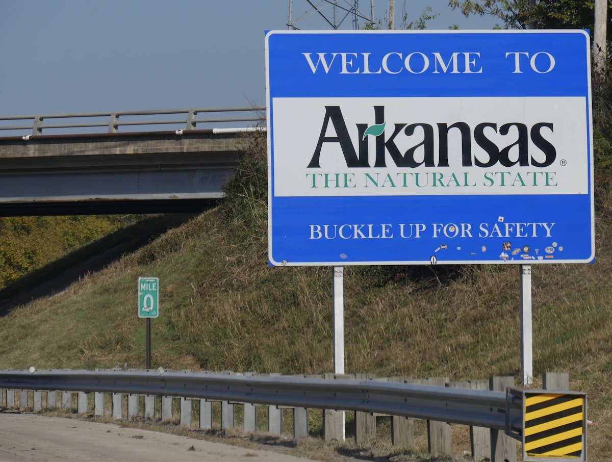 Briefly: Arkansas law requires all truck drivers to read, write, speak English