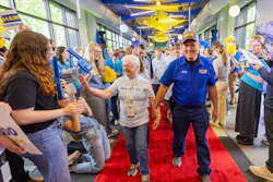 J.B. Hunt company driver Elvis, who surpassed four million safe miles driven recently, walks the red carpet with his family during the 2025 Million Mile Walk of Fame at company headquarters in Lowell, Arkansas