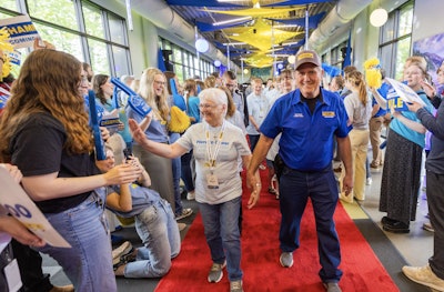 J.B. Hunt company driver Elvis, who surpassed four million safe miles driven recently, walks the red carpet with his family during the 2025 Million Mile Walk of Fame at company headquarters in Lowell, Arkansas