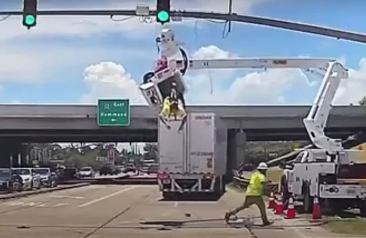 Watch as worker is left suspended after truck hits bucket truck boom ...