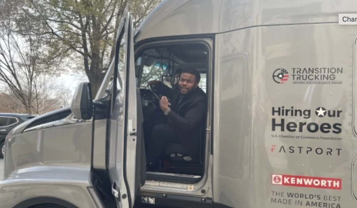 Charles Jones, Jr. in the Kenworth T680 he received for winning the Transition Trucking: Driving to Excellence Award
