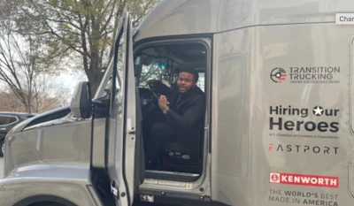 Charles Jones, Jr. in the Kenworth T680 he received for winning the Transition Trucking: Driving to Excellence Award