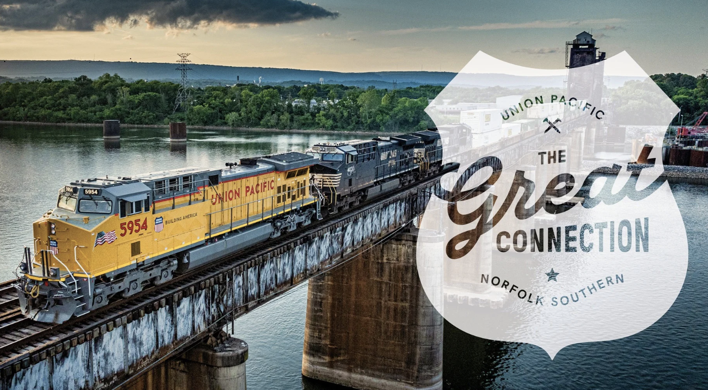 Union Pacific train crossing river bridge with 'The Great Connection' logo