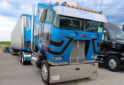 Dennis Sikorski's blue 1995 Peterbilt 362 and 2007 Great Dane reefer trailer “Old School & Flat Broke”