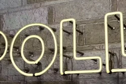 Cream-colored neon sign spelling 'POLL' mounted on a textured gray brick wall