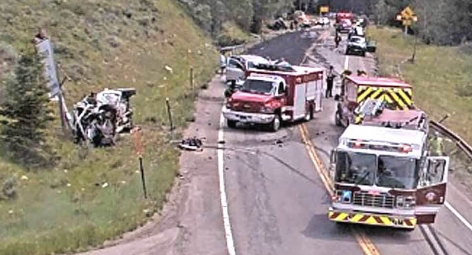 Emergency response vehicles at highway accident scene with multiple fire trucks and responders