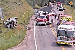 Emergency response vehicles at highway accident scene with multiple fire trucks and responders