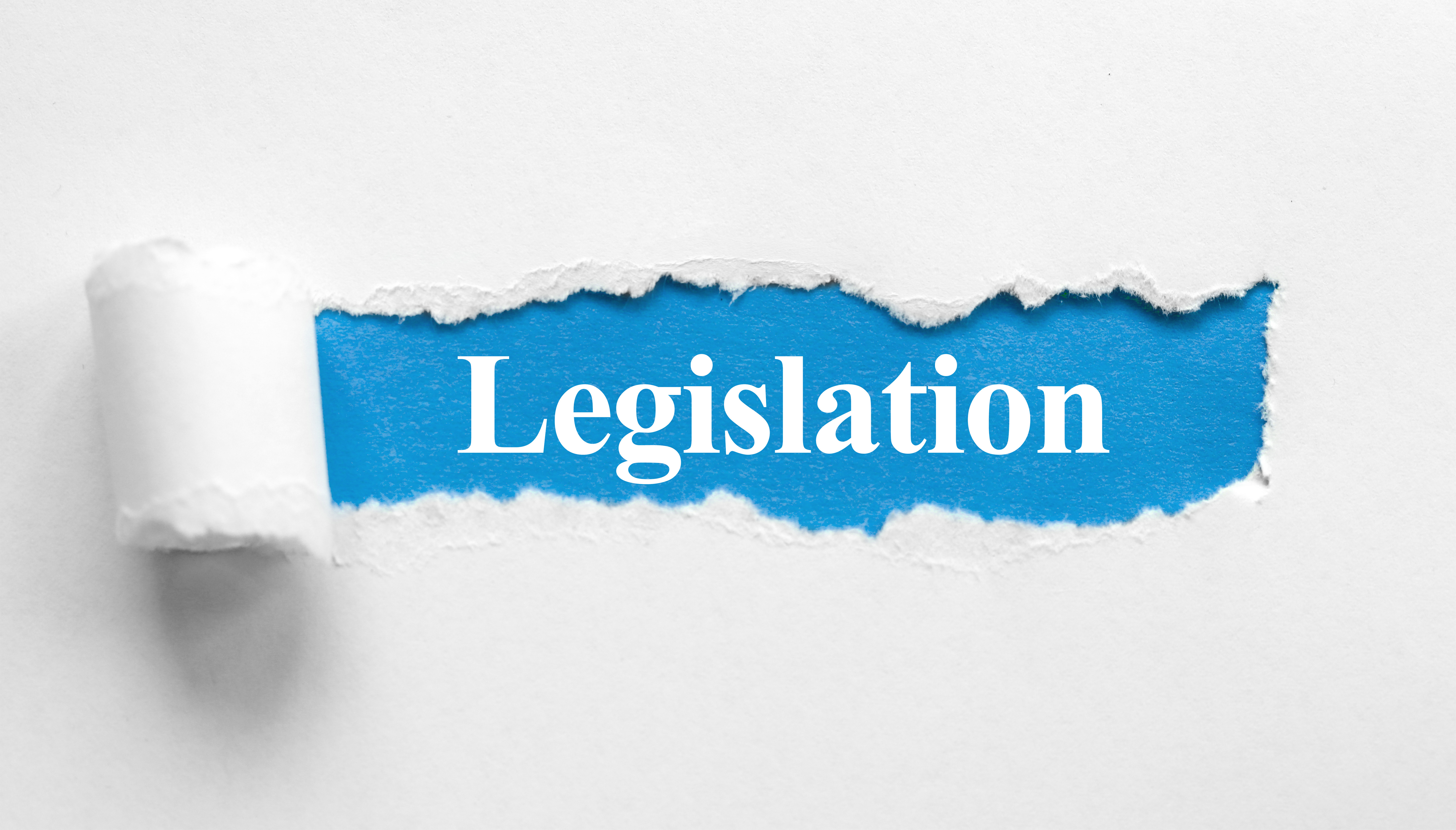 Torn white paper revealing blue banner with 'Legislation' text
