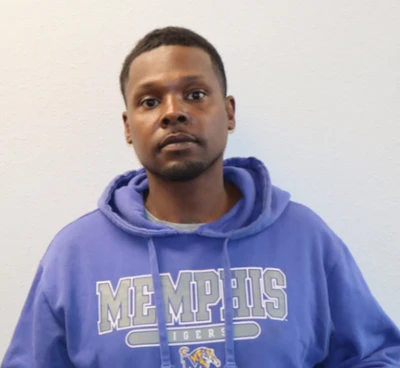 Person wearing blue Memphis Tigers hoodie against neutral background