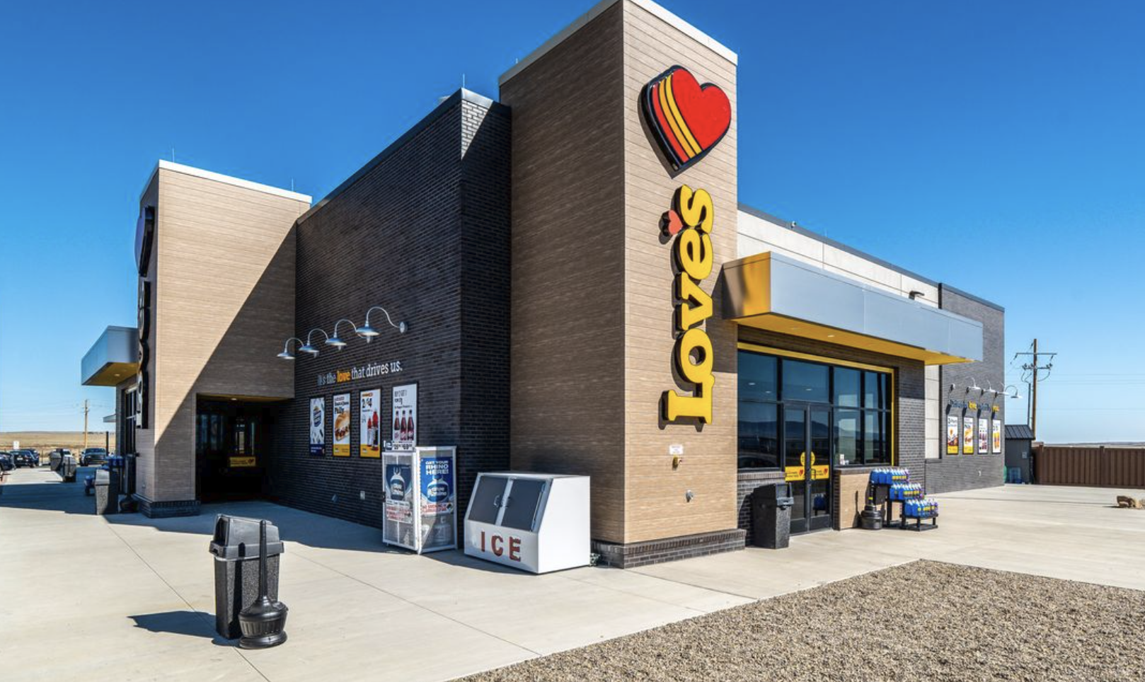 Love's Travel Stop building exterior with red heart logo and yellow signage under clear blue sky