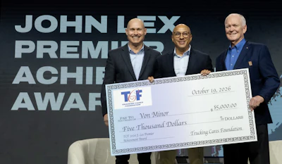 Three men in business attire holding a $5,000 ceremonial check from TCF at a Premier Achievement Award event.
