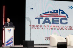 Professional speaker at podium during TAEC Trucking Association Executives Council conference presentation