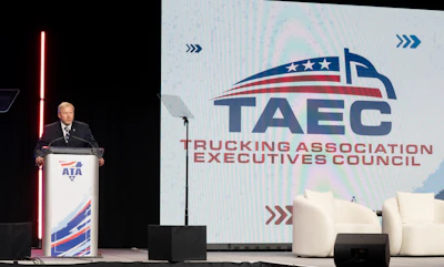 Professional speaker at podium during TAEC Trucking Association Executives Council conference presentation