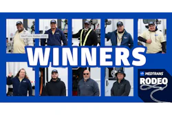 MedTrans Rodeo 2026 winners group photo featuring nine team members wearing branded caps and jackets